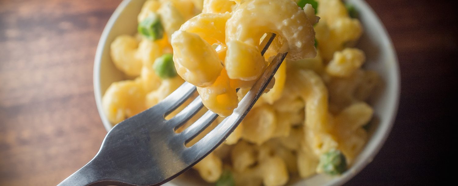 Mac n cheese on fork.